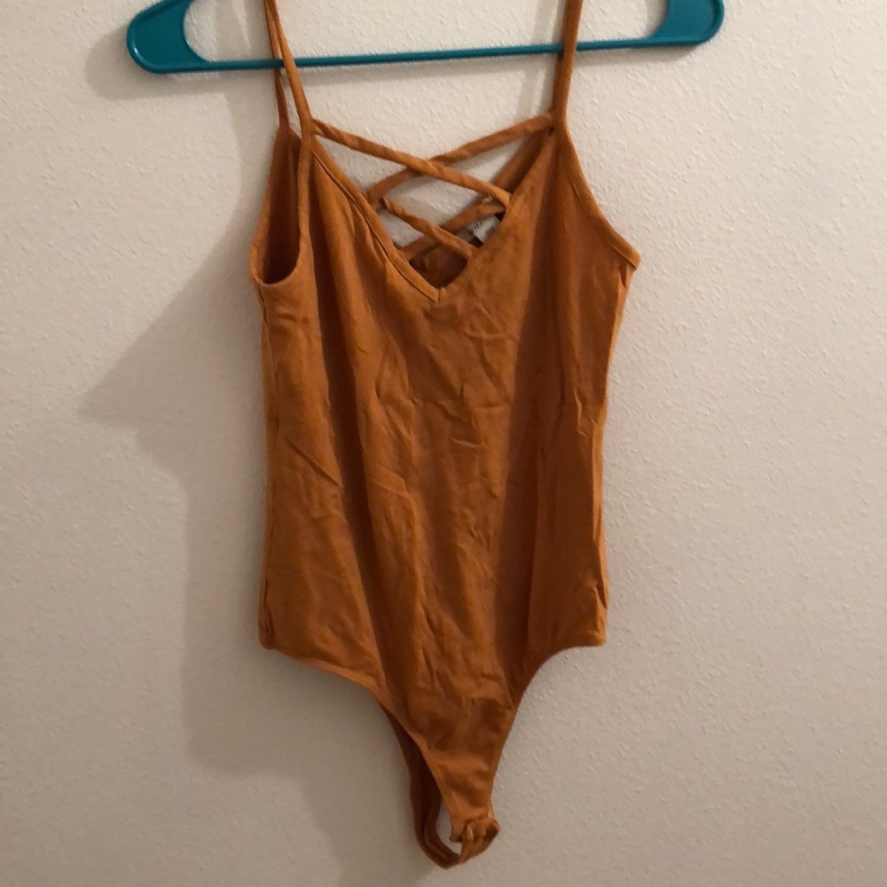 Romper, mustard color, v neck with cross.